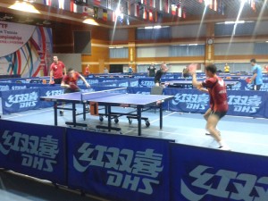 Aaron and Kim prepare for their matches in the busy warm-up hall